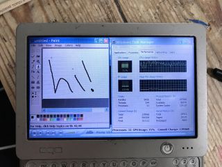 OQO Model 01 UMPC doing some multitasking in Windows XP, showing MS Paint, Windows Media Player 10 and the Task Manager open. The CPU was running at 71% usage here