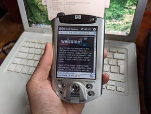 HP iPAQ h5550 displaying a local copy of my website (hosted from that same 2009 MacBook) using the version of Internet Explorer included with Windows Mobile 2003.