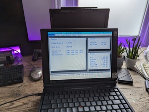 Photo of the HP Omnibook 5700CT displaying it's BIOS setup screen, listing some general system information in three separate boxes. Notable info shown include the following:
            Floppy Drive A = 1.44 MB
            Hard Drive = 2067 MB (which is 2 GB)
            CPU Type = Pentium
            Bus Clock = 150 MHz
            Total RAM = 32768 KB (which would be 32 MB)
            The laptop itself has some stickers on the screen bezel, showing this actually has a Pentium MMX CPU and was originally designed to run Windows 95.