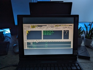 Photo of Impulse Tracker version 2.14p5 running on the Omnibook running in MS-DOS mode (I think). One of the sample module files (Blue Flame by Chris Jarvis) is playing, which has 18 channels and a total order number of 41