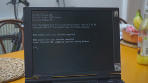 Picture of the Omnibook loaded into a DOS shell from it's original install of Windows 95. Here, it was unable to properly boot; displaying a message saying: "Cannot find WIN.COM, unable to continue loading Windows", with a DOS prompt below it. Above those are some output from the BIOS and Windows; listing the CPU type/speed, external cache (512K) along with some stuff loaded from the AUTOEXEC.BAT (like a Power Management time correction driver)