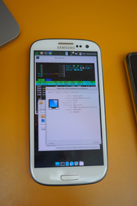 Galaxy S3 with various windows open in Xfce. A terminal window with htop is open, displaying the usage of the 4 CPU cores in the phone, along with memory usage (which in this case was displaying 219 MB used out of the 1 GB available). In front of the terminal window, the Thunar file manager is open, along with the Xfce about screen displaying some system information. This lists the following:
            Device: samsung-m0
            OS Name: postmarketOS v22.12.2
            OS Type: 32-bit
            Xfce Version: 4.16
            Distributor: Alpine Linux
            CPU: ARMv7 Processor rev 0 (v7l) x 4
            Memory: 998.6 MiB
            GPU: Mali400