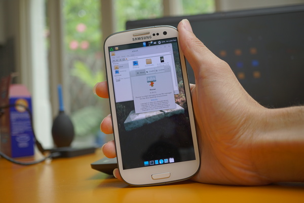 Galaxy S3 running postmarketOS v22.12.2 with its custom config of the Xfce desktop environment. A Thunar file manager window is open with the about screen as well, which shows it has Thunar version 4.16.11 installed, along with a description that reads "Thunar is a fast and easy to use file manager for the Xfce desktop Environment".
