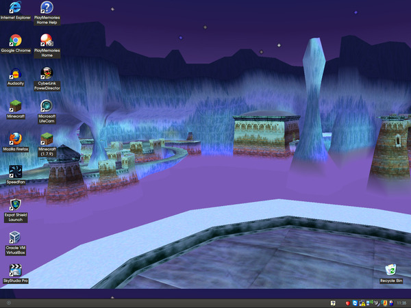 Screenshot of a Windows XP desktop taken from a ThinkPad X32. The background used here is a screenshot of the Ice Cavern level from the original Spyro the Dragon game on PS1. A few icons for applications are on the desktop; including Internet Explorer 6, Chrome, Audacity, two different Minecraft versions (one is 1.7.9, the other is an older one I can't remember), Firefox 3.6, SpeedFan, Expat Shield, VirtualBox, SkyStudio Pro, PlayMemories Home, Cyberlink PowerDirector 8 and the viewer software for a Microsoft Lifecam webcam. This also has a custom appearance added, which has a somewhat dark, minimal appearance. The start button graphic in particular is replaced with a circle illustration of some kind